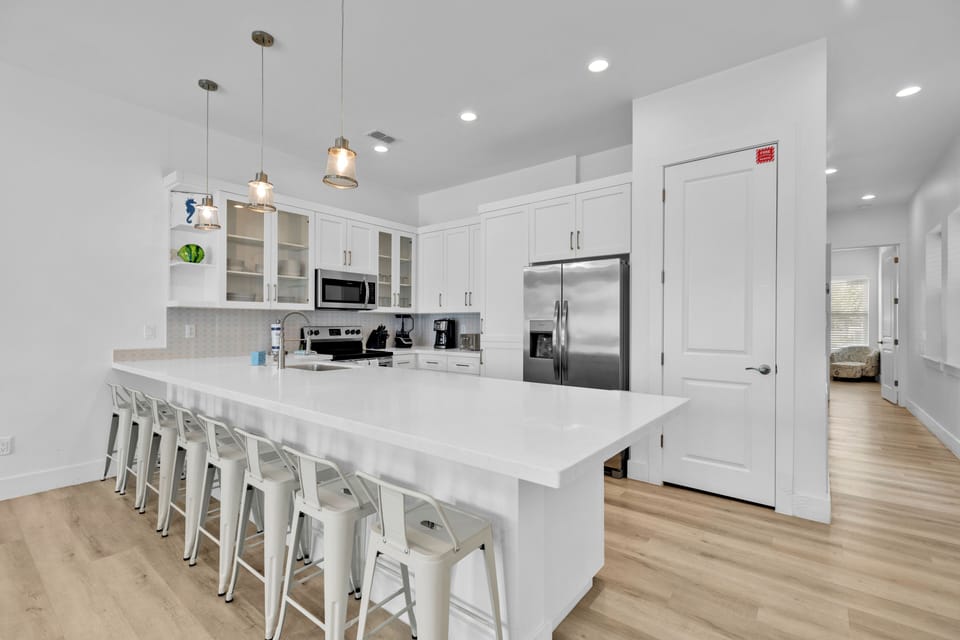 The oversized kitchen island gives everyone a place to gather, whether you're preparing breakfast or sharing evening snacks.