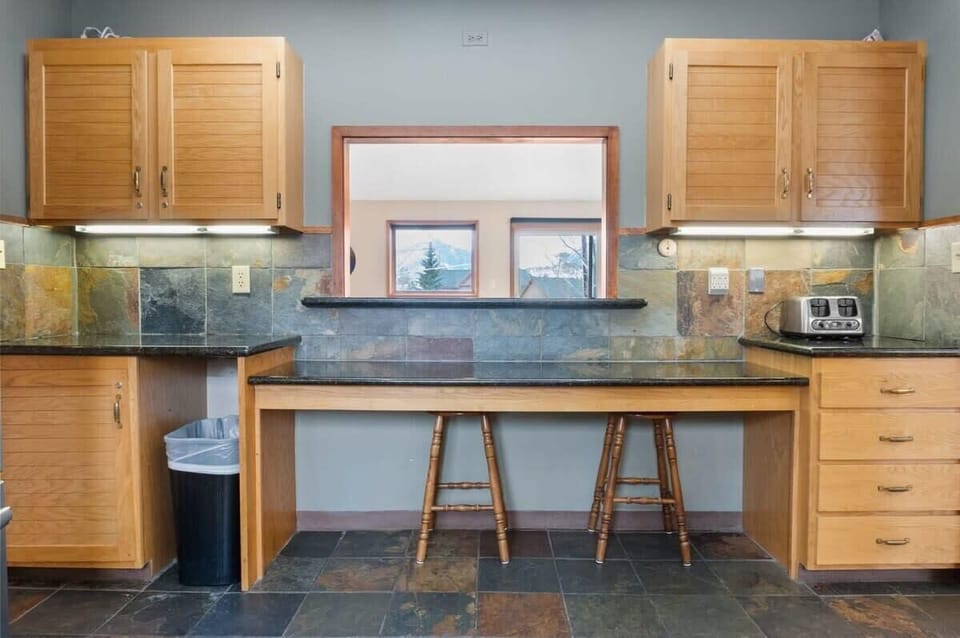 The built-in table located in the kitchen is a cozy spot to grab a snack or hang out while keeping the chef company.