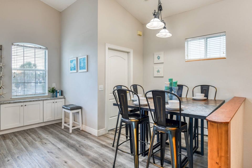 Gather around the dining table for good food and memories. The laundry room is conveniently located inside that door.