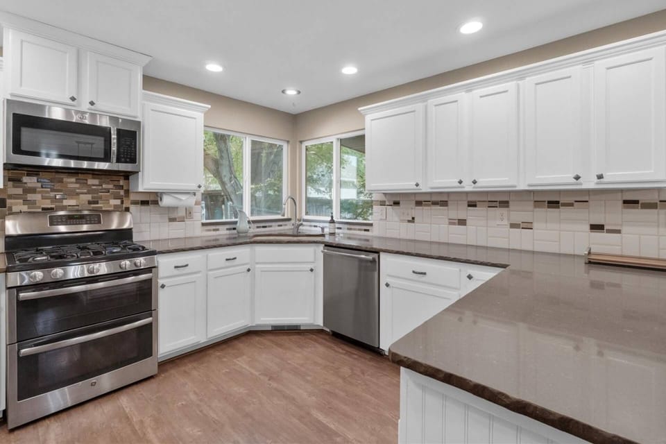 Spacious kitchen with granite countertops and peninsula with seating