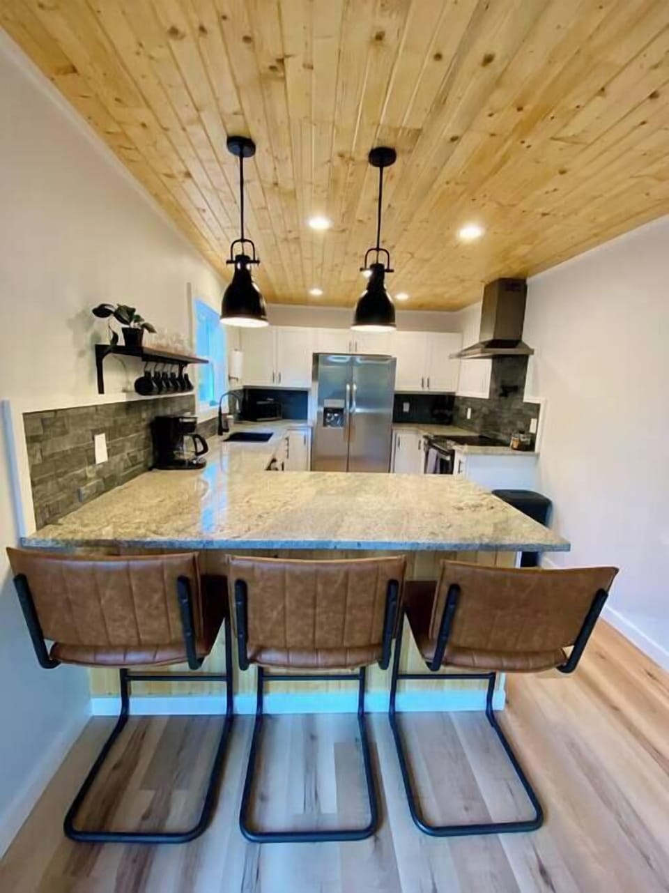 Fully stocked modern kitchen with breakfast bar