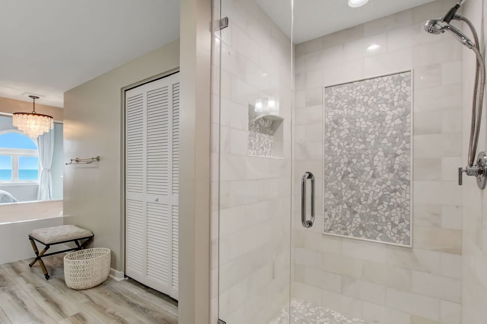 Newly Renovated Master Bathroom with Quartz Countertops, a Soaking Tub, and a Tiled Walk In Shower