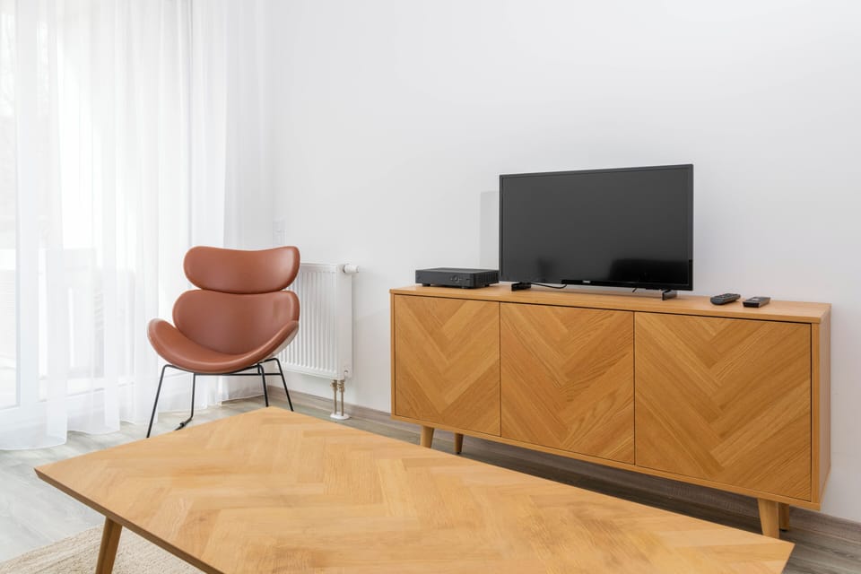 Deluxe Two-Bedroom Apartment with Balcony | Living area | 110-cm Smart TV with digital channels