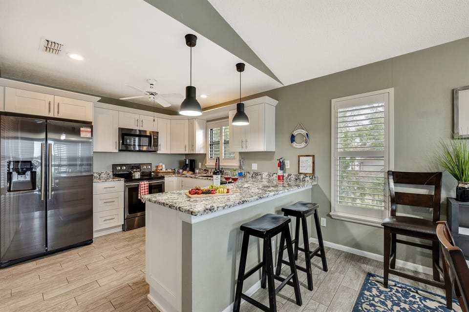 The white cupboards provide ample storage space for your culinary needs, ensuring that everything is within reach.