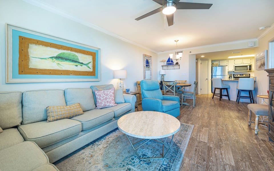 Unwind on the plush sofa with a queen sleeper, surrounded by coastal decor, as you create cherished family moments