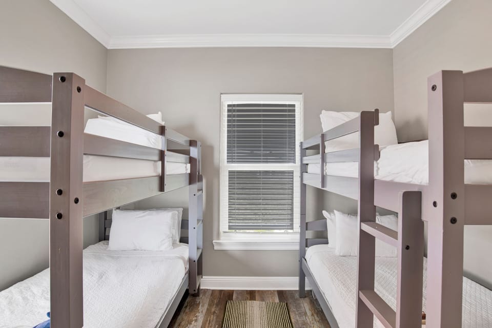 Bedroom 4 has a TV and two sets of Twin bunk beds, sleeps 4