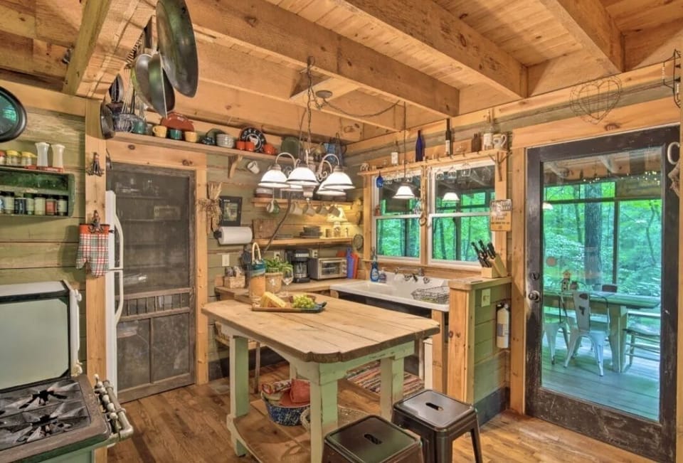 cozy kitchen is fully stocked with all you need to cook and serve a meal.