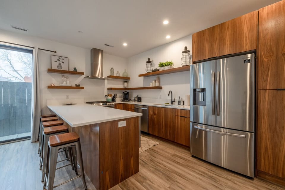 Fully equipped kitchen with sleek wood cabinetry and stainless steel appliances