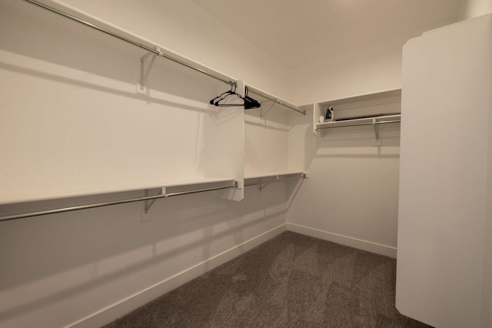 Spacious walk-in closet with built-in shelving and storage