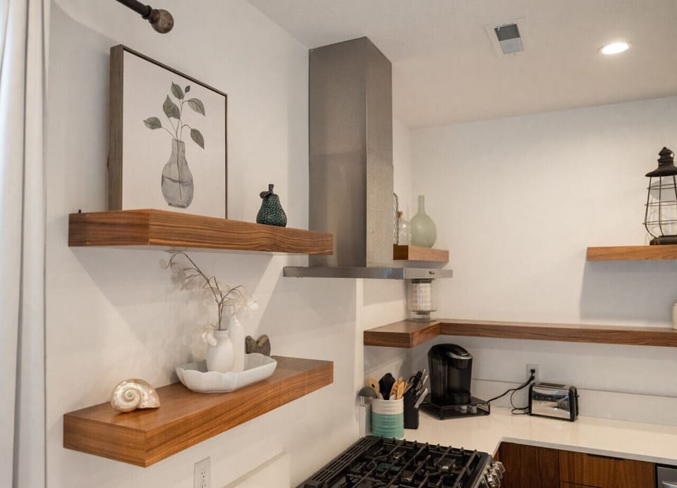Stylish kitchen shelving with modern range and decor accents