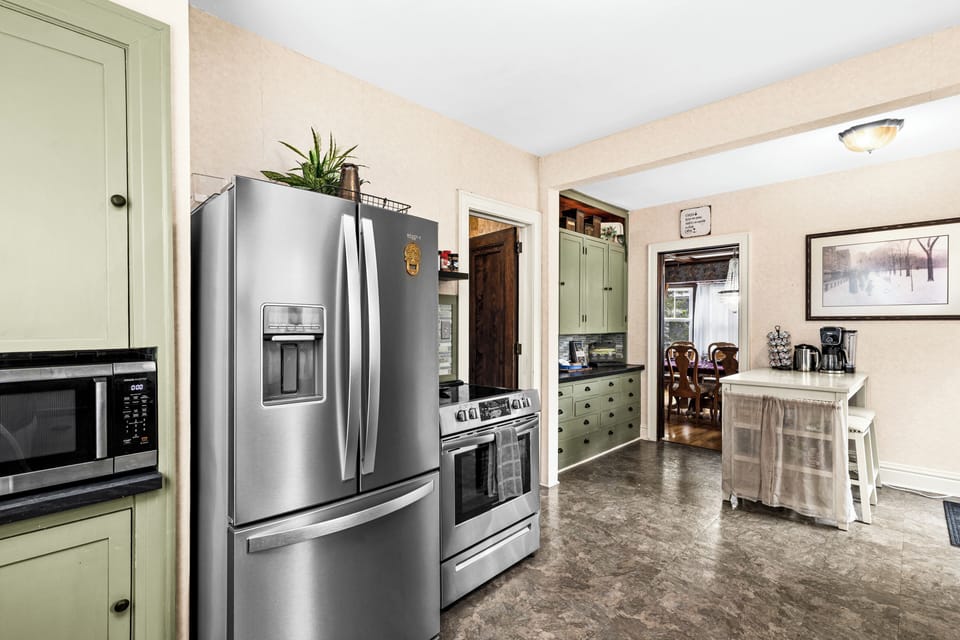 Stainless fridge with ice and water, electric range and microwave.