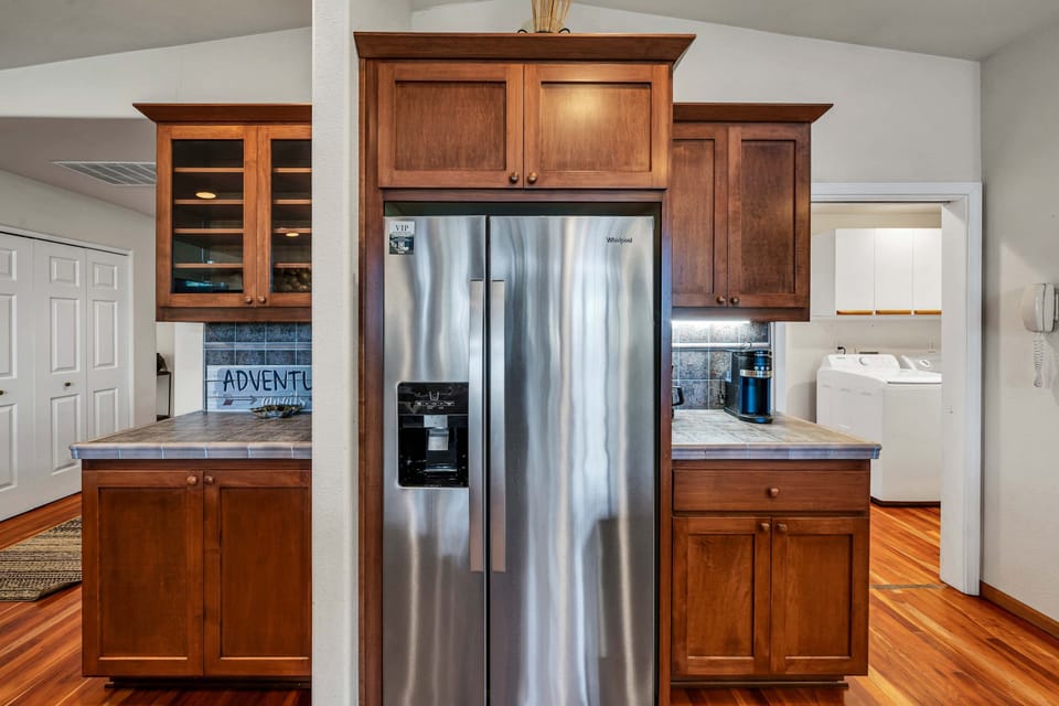 The spacious kitchen features a large kitchen island with 2 barstools, stainless steel appliances, and everything you need to cook a delicious meal for your group.