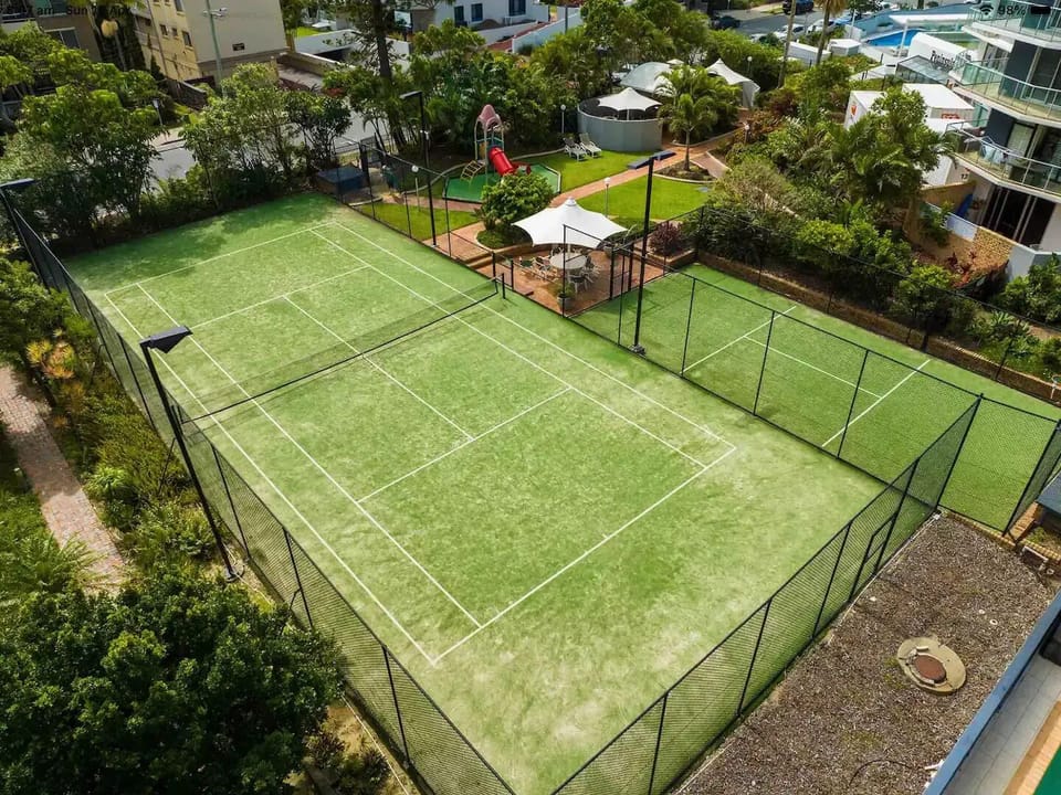 full sized tennis court and basketball hoop