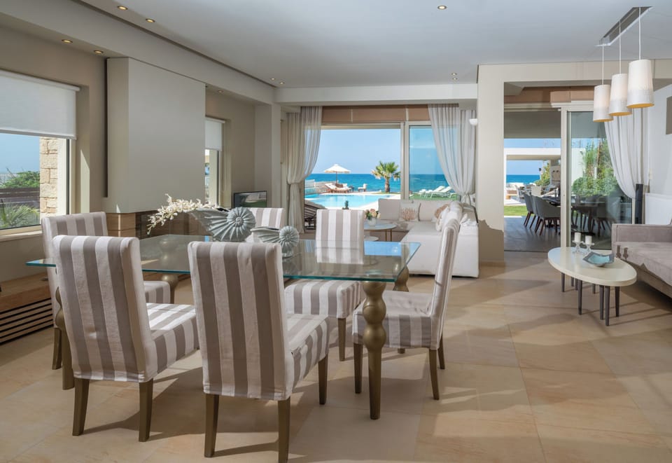 Enjoy elegant indoor dining at the stylish table for 6 in Hersonissos Beach Villa.