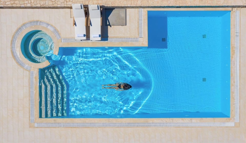 Sip and swim: Delight in a refreshing cocktail by the pool while enjoying the breathtaking surroundings.