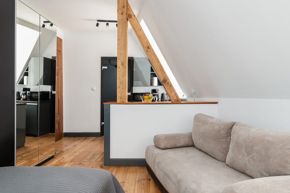 A wide-angle view of the kitchen and living area, showcasing a practical open-plan layout.

