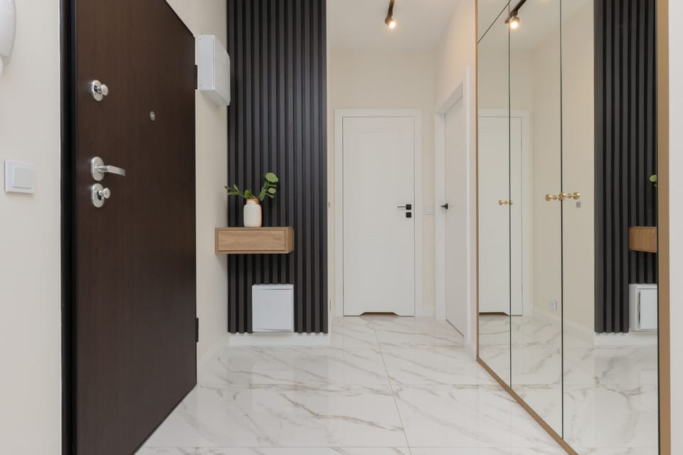 Bright, spacious hallway with large wardrobe with mirrored doors.