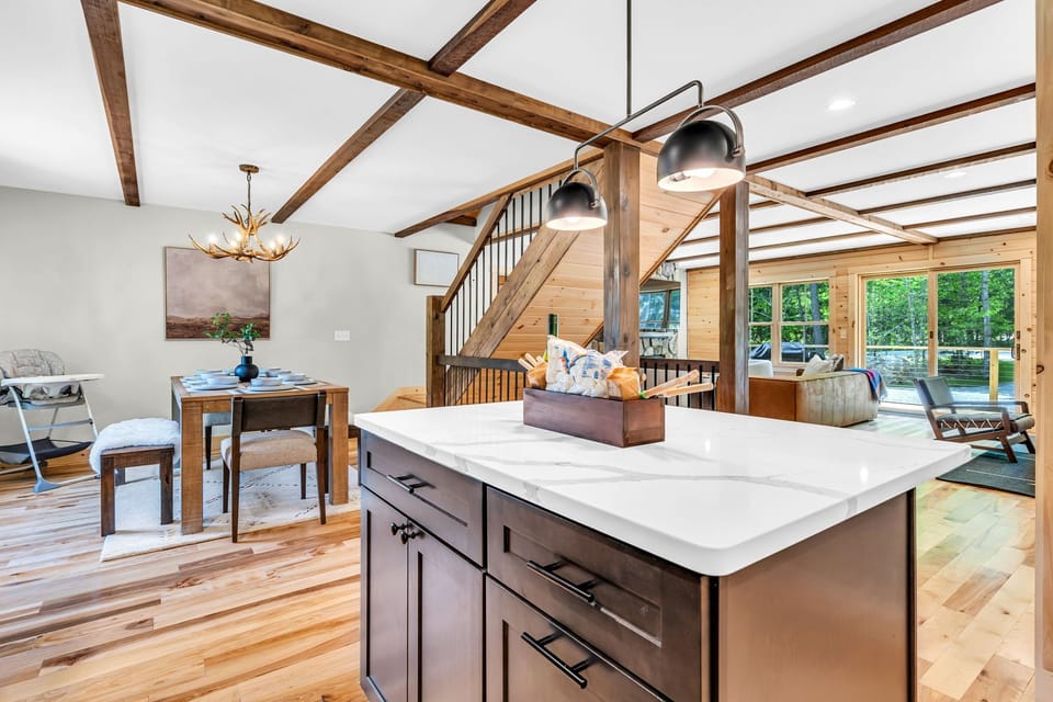 Modern kitchen island with open flow into living and dining areas


