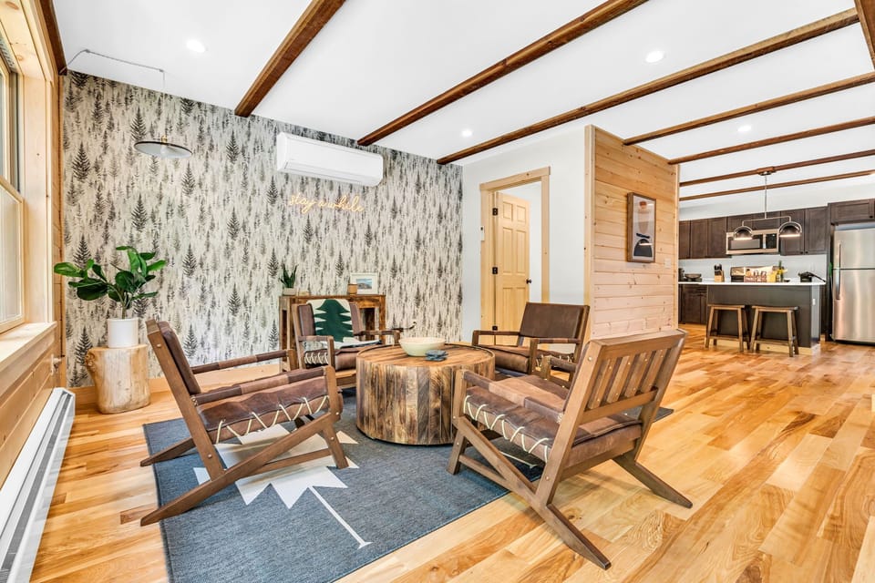 Bright and spacious living area with large windows and forest views