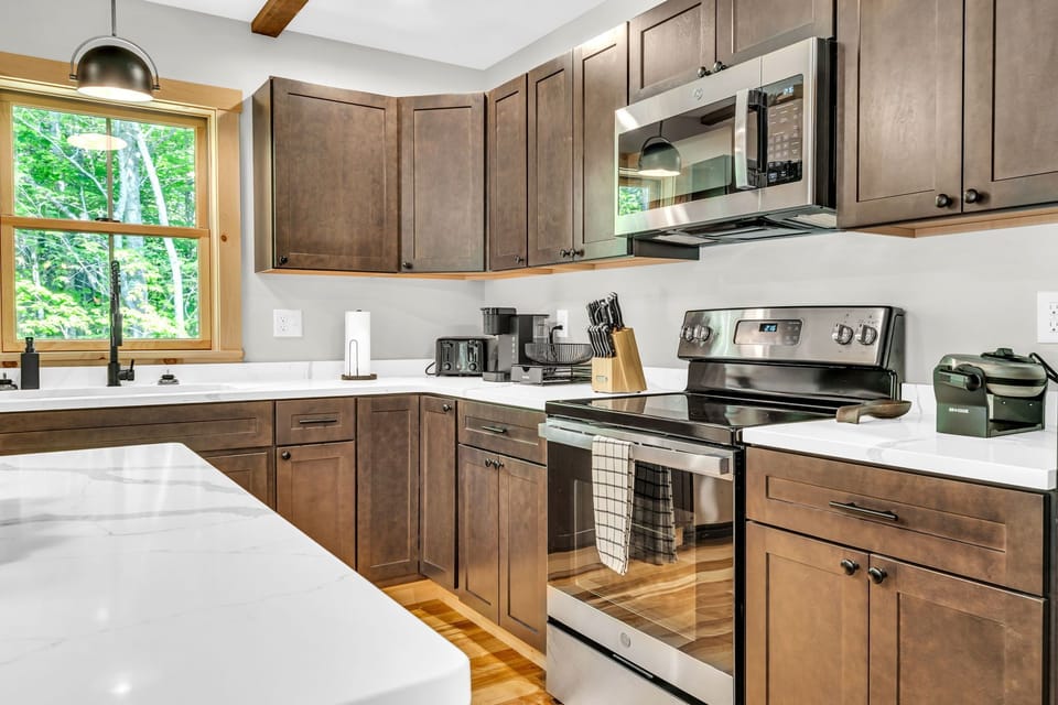 The fully stocked kitchen awaits guests with a comprehensive array of provisions, ensuring a seamless and enjoyable culinary experience.