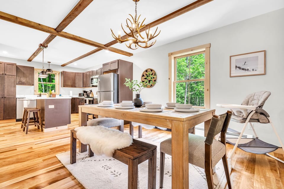 Open-concept dining and kitchen area with warm wood finishes