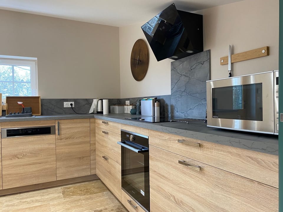 The kitchen - washing machine dishwasher induction hob oven microwave fridge