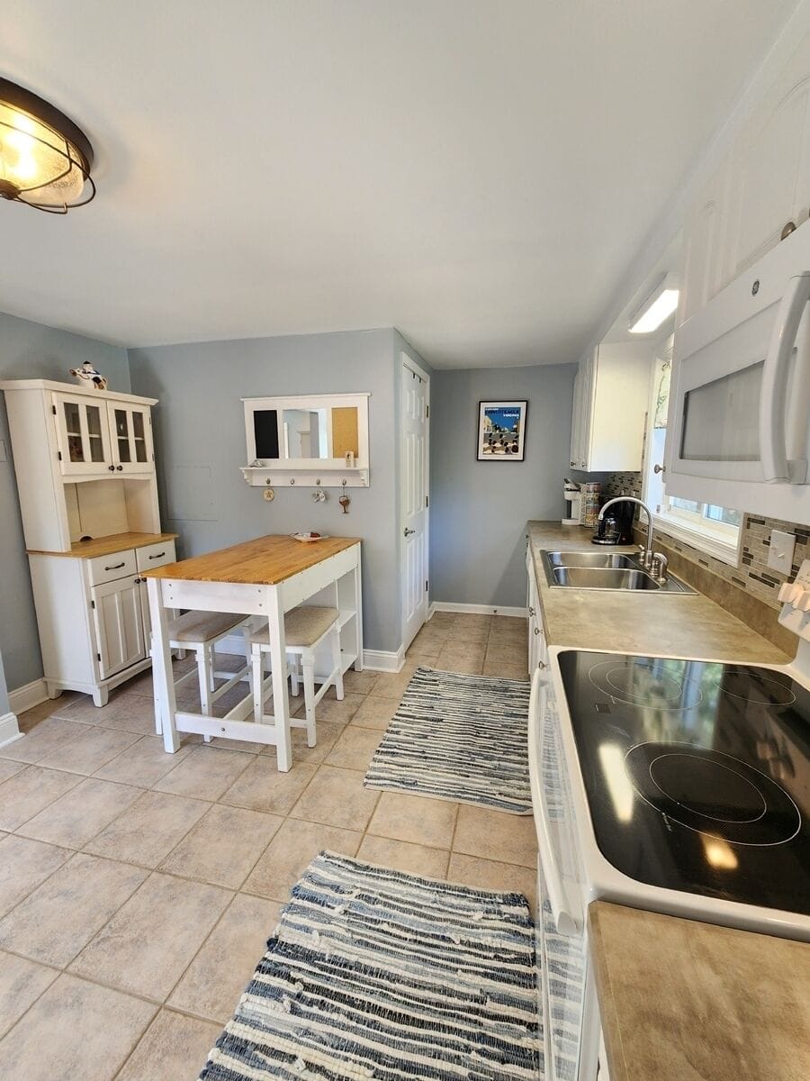Fully equipped kitchen with dining area perfect for quick bites and morning coffee.