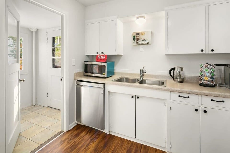 Brew coffee, heat snacks, or prep meals in this sunny kitchen—stocked with essentials for easy, stress-free stays.