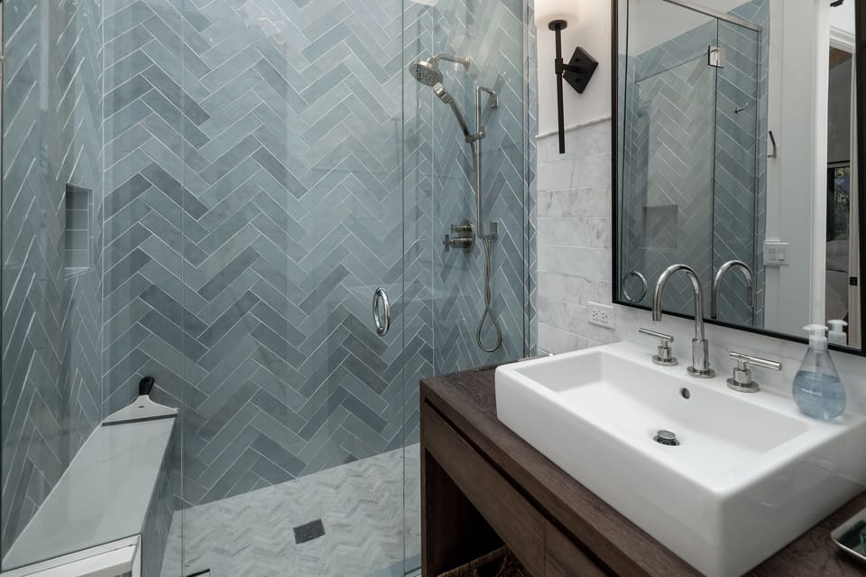ust between Bedrooms #3 and #2, you'll find the hall bathroom, featuring a beautifully tiled, glass-enclosed shower—perfect for freshening up