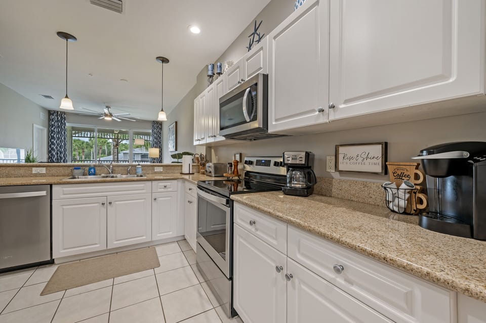 Fully equipped renovated kitchen with a dishwasher, microwave, coffee area, more
