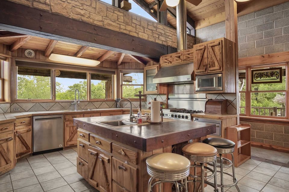 The kitchen's central island, complete with its own sink, provides even more meal prep and presentation space!