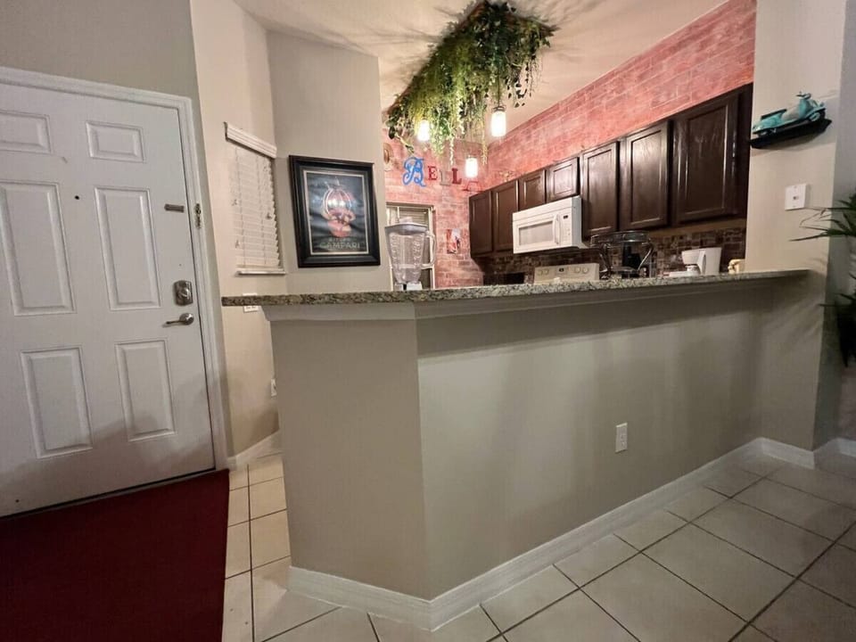 Cook with ease in the fully equipped modern kitchen featuring stainless steel appliances, plenty of counter space, and everything you need for family favorites or quick snacks.