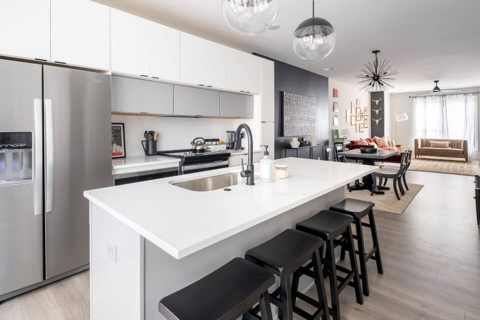From the quartz countertops to the stainless appliances, every detail has been carefully curated to create a space that is both functional and beautiful. Fully stocked kitchen for cooking meals at home.