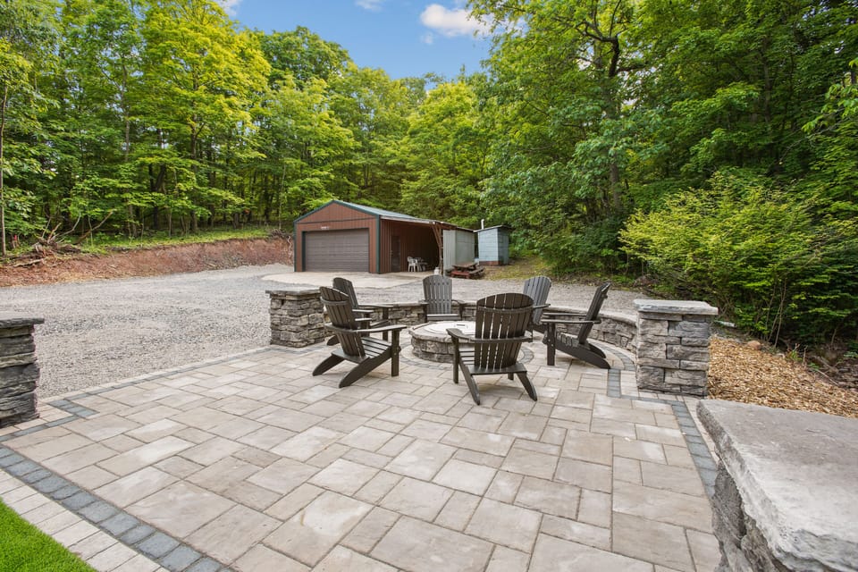 6 comfortable chairs for you to enjoy around the Breeo fire pit. The separate garage is where you will find the bikes.