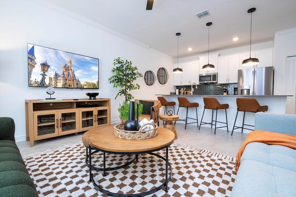 Welcome to our spacious and beautifully adorned living room, complete with a state-of-the-art smart TV where you can stream all your favorite channels and shows. 