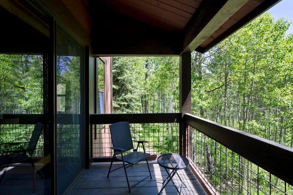Sit back and listen to the sounds of nature from the private balcony surrounded by trees.