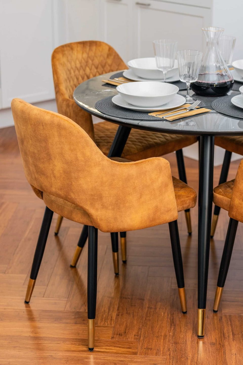 A close-up of the dining table and mustard chairs, set for a delightful meal.
