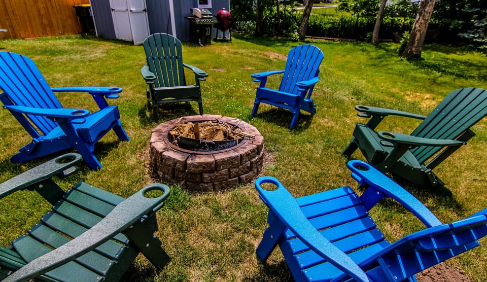 Private backyard fire pit with Adirondack chairs, perfect for s’mores, stargazing, and relaxing after a day on the lake.