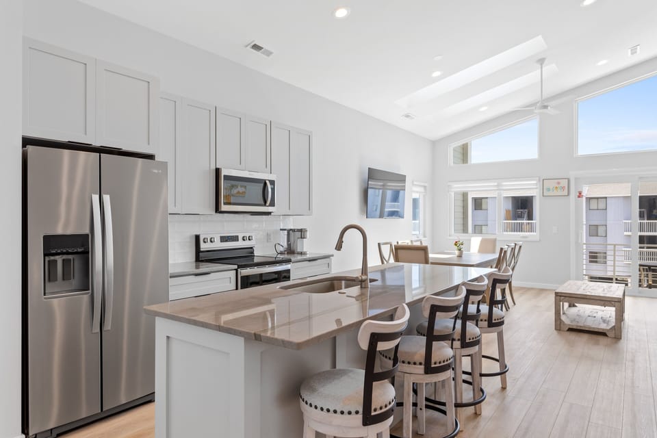 The open kitchen area with countertop seating for 4