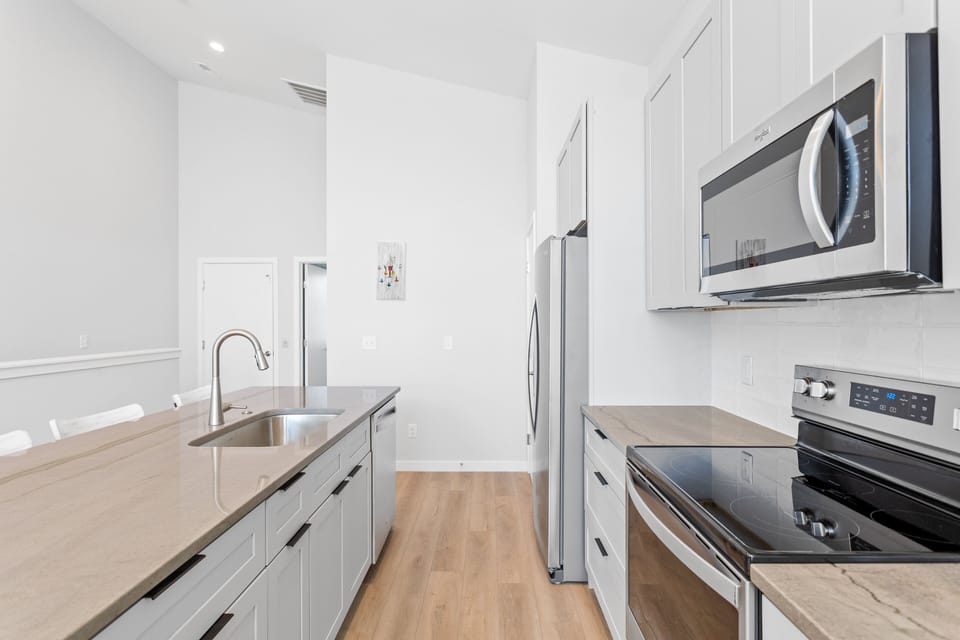 The open kitchen area with countertop seating for 4