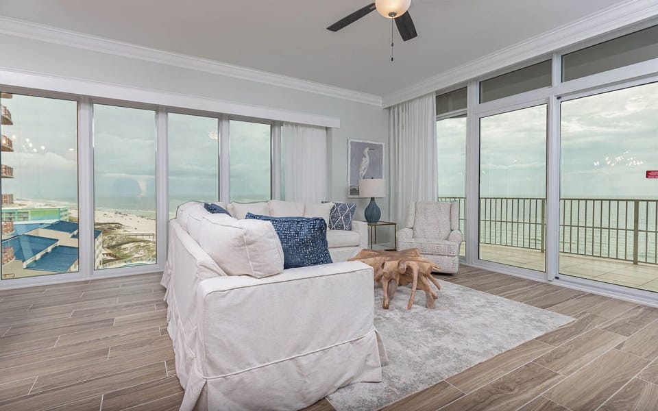 Relax on the cozy sofa with a queen sleeper in this inviting family room with panoramic beachfront views