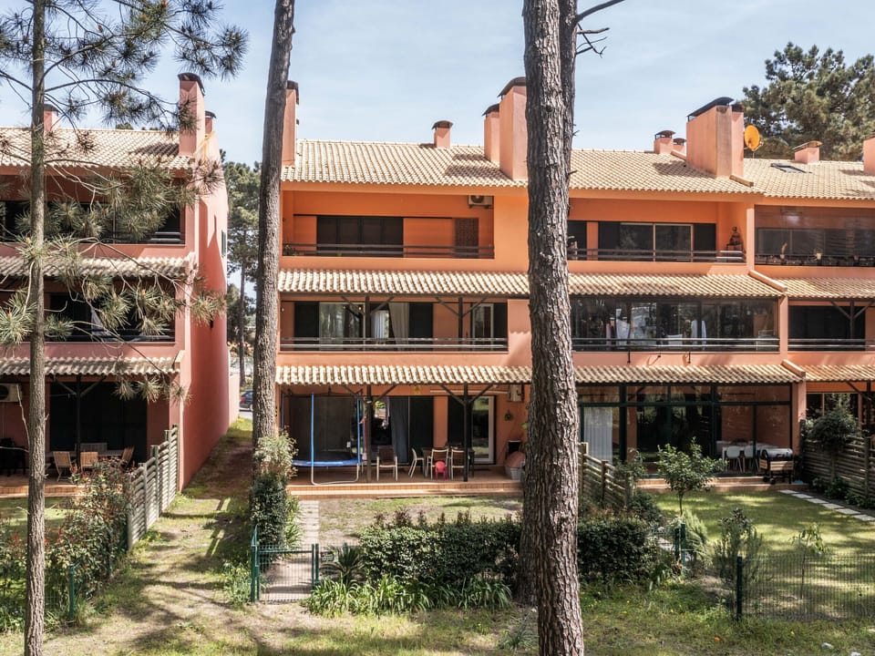 Terracotta townhouse exterior with pine trees — Apartment Pedro, holiday apartment in Portugal