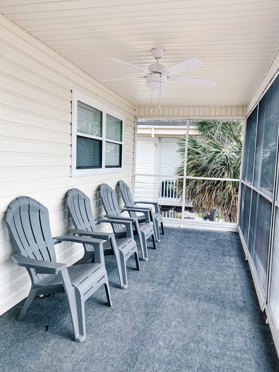 Screened in porch with Adirondack chairs overlooking canal. 