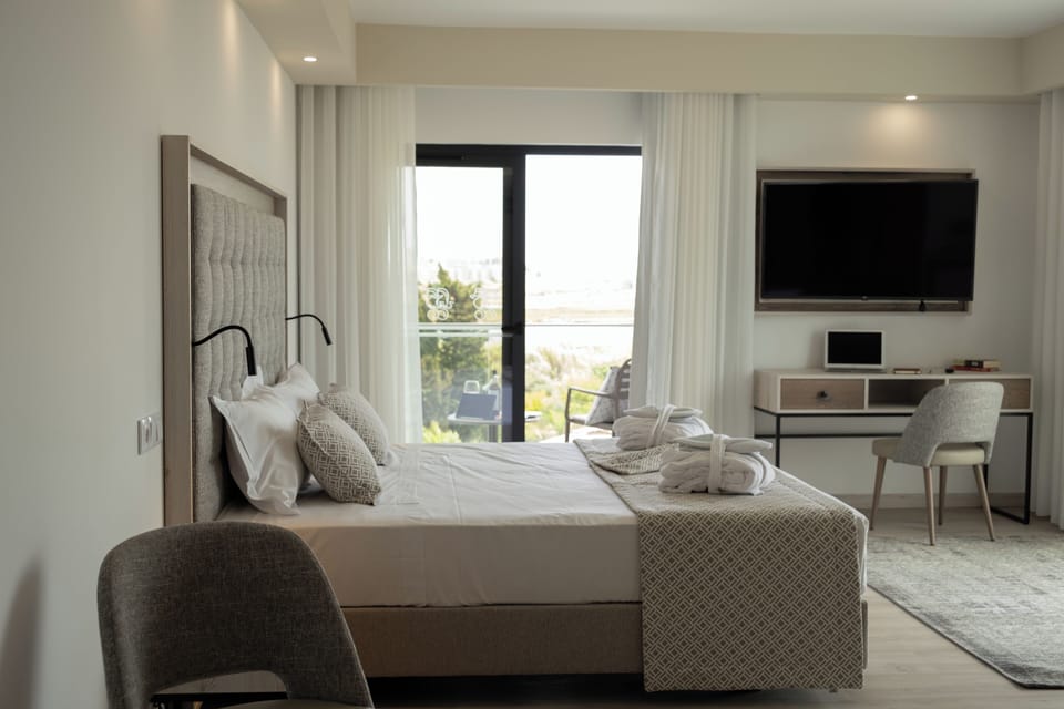 Deluxe Room | Minibar, in-room safe, desk, blackout drapes