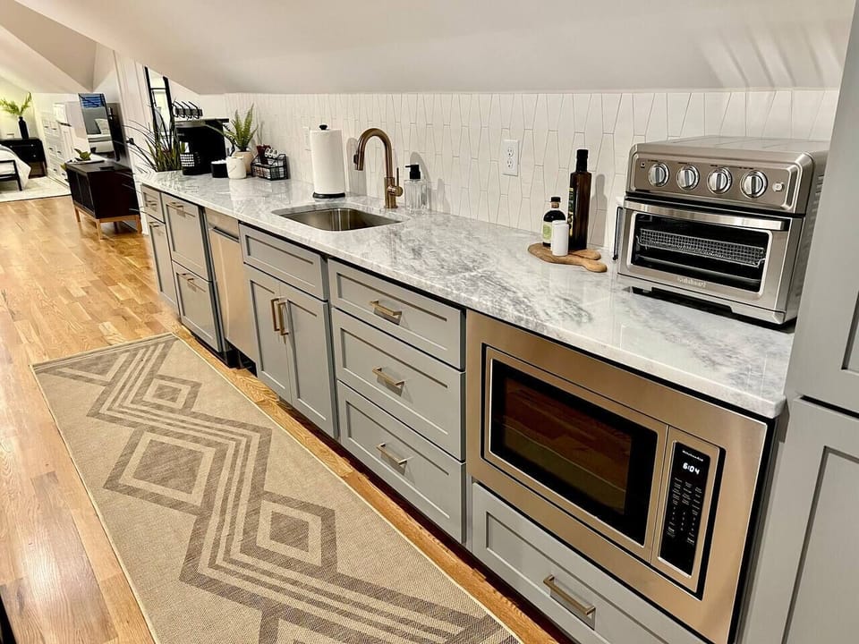 A nice long counter for prepping dinner in or organizing the take-out!  There is a microwave and toaster oven for reheating last night left-overs!