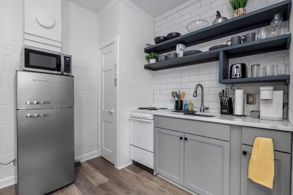 Full Kitchen with stove, refrigerator, coffee, toaster, blender, and utensils