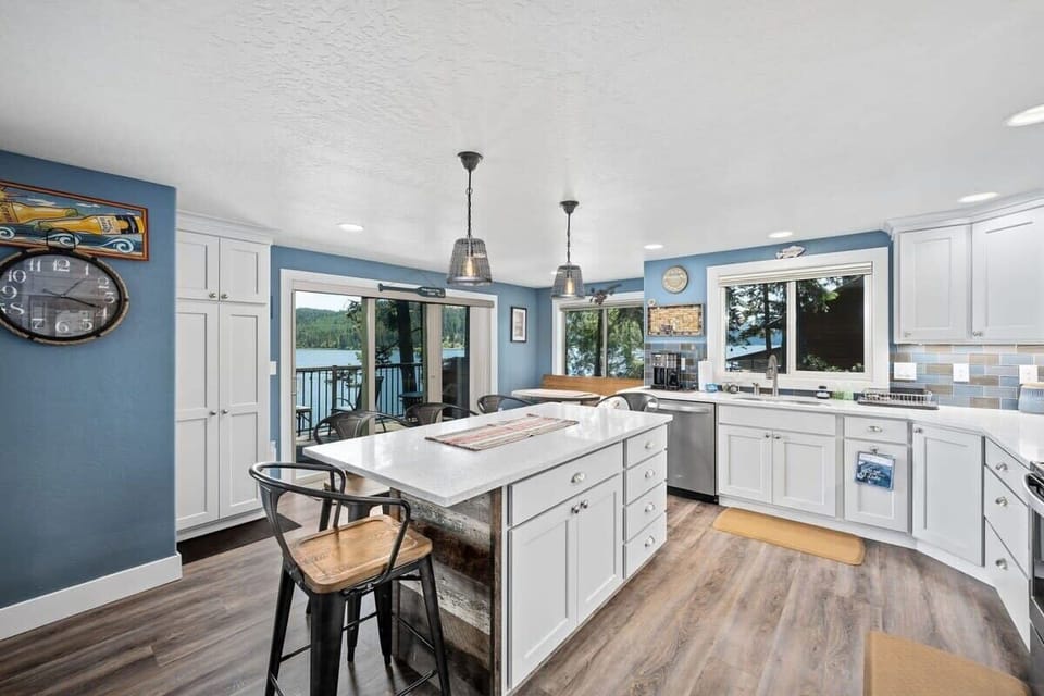 Gather around your spacious kitchen island while meals simmer and conversations flow, with stunning water views as your backdrop.