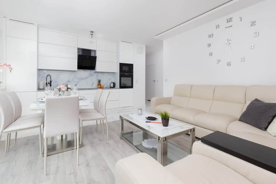 A spacious and bright living and dining area, blending comfort and functionality with chic furnishings.
