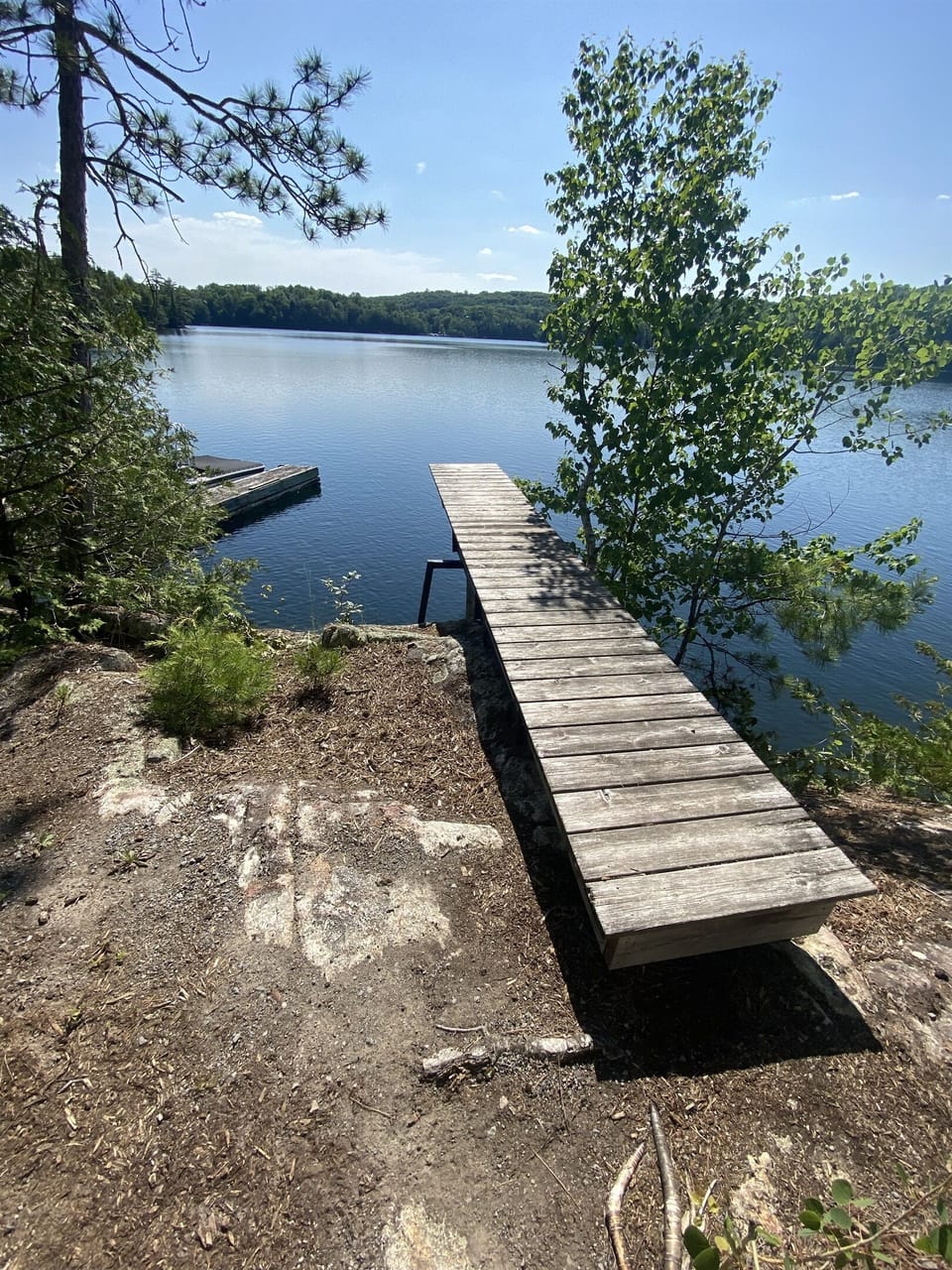 Diving board off cliff into deep waters of Lac Dame