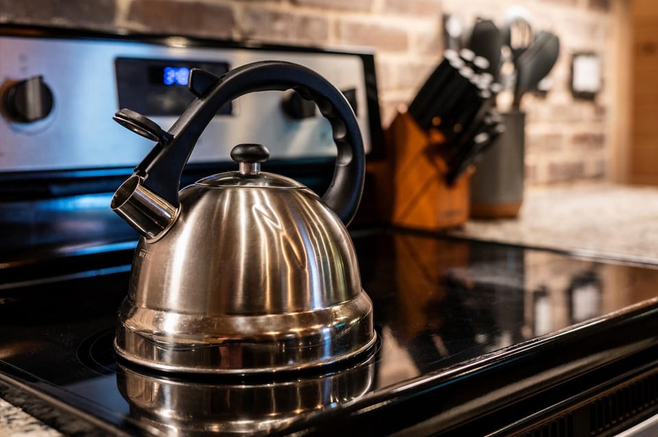Whistling tea kettle ready for a cozy cup by the fire.
